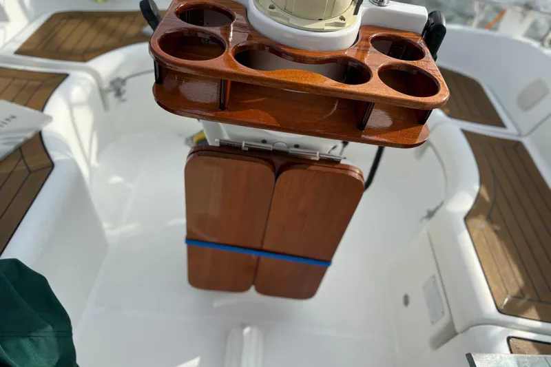 Slide: The Image of Cockpit of 2001 Beneteau 361 sailboat with wooden table and cup holders. - 7