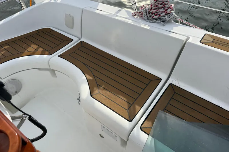 Slide: The Image of Cockpit of 2001 Beneteau 361 sailboat with teak seating and coiled rope. - 8
