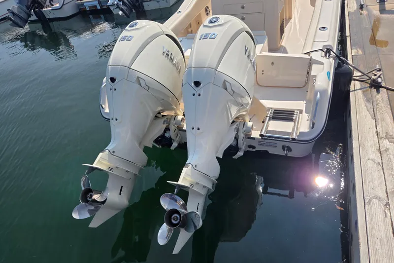 Slide: The Image of 2025 Grady-White Fisherman 257 with twin 150 horsepower outboard engines docked. - 10