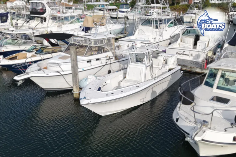 Slide: The Image of 2022 SeaVee 290B boat docked among other vessels in a marina. - 1