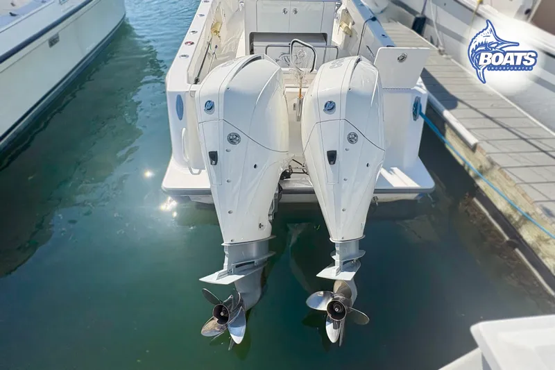 Slide: The Image of 2022 SeaVee 290B boat with dual outboard engines docked in marina. - 14