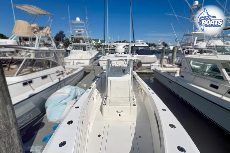 Slide: The Image of 2022 SeaVee 290B boat docked among other vessels under a clear blue sky. - 3