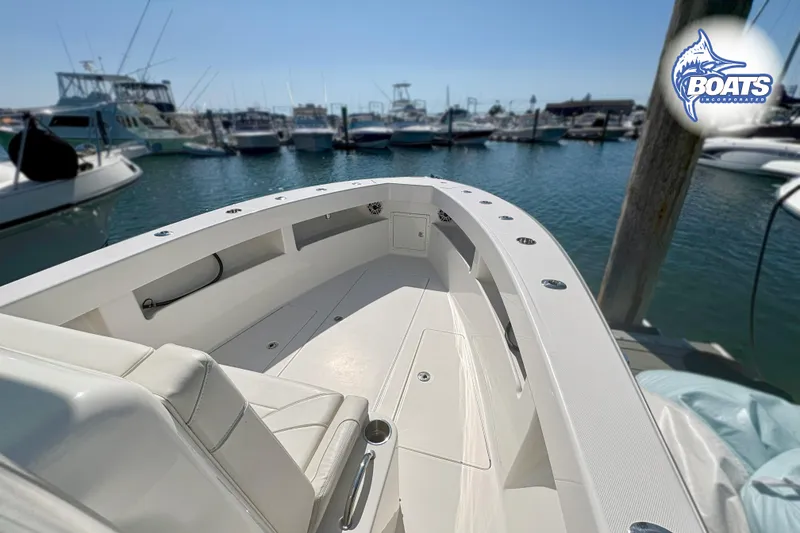 Slide: The Image of 2022 SeaVee 290B boat docked in a marina, showcasing spacious deck and seating. - 5