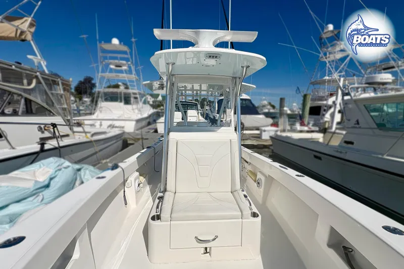 Slide: The Image of 2022 SeaVee 290B boat docked, showcasing sleek design and spacious deck. - 6