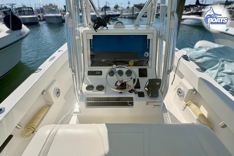 Slide: The Image of 2022 SeaVee 290B boat console with steering wheel and navigation equipment at marina. - 9