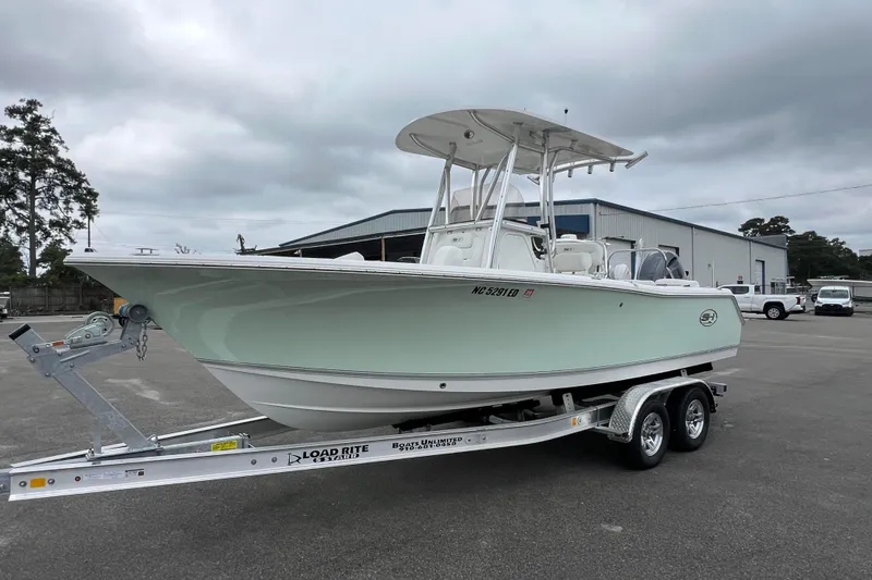 Slide: The Image of 2016 Sea Hunt Ultra 225 boat on trailer in parking lot, overcast sky. - 5