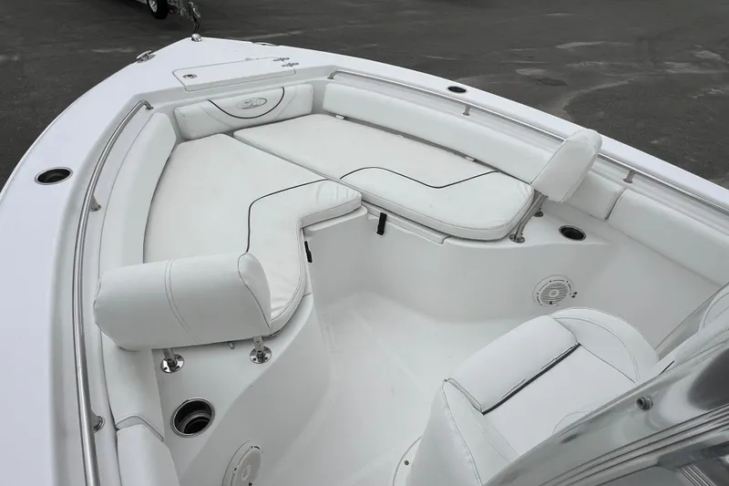 Slide: The Image of 2016 Sea Hunt Ultra 225 boat with white cushioned seating and sleek design. - 6