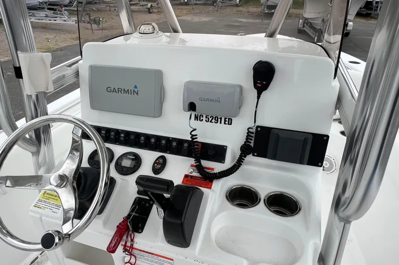 Slide: The Image of 2016 Sea Hunt Ultra 225 boat console with Garmin navigation, steering wheel, and controls. - 8