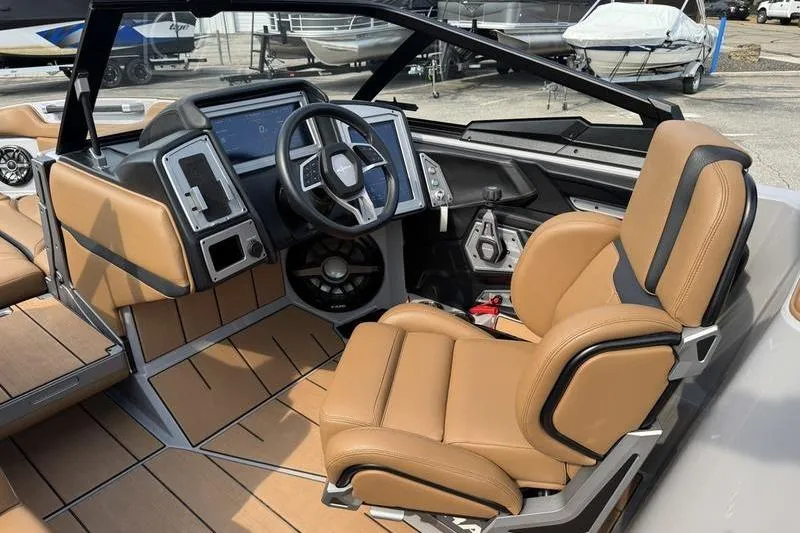 Slide: The Image of 2023 Supra SL boat interior with tan leather seats and modern dashboard. - 10