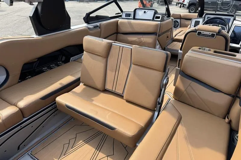 Slide: The Image of 2023 Supra SL boat interior with luxurious tan leather seating and modern dashboard. - 11