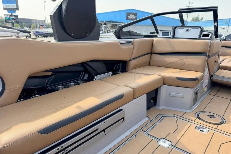 Slide: The Image of 2023 Supra SL boat interior with tan leather seating and modern dashboard. - 12