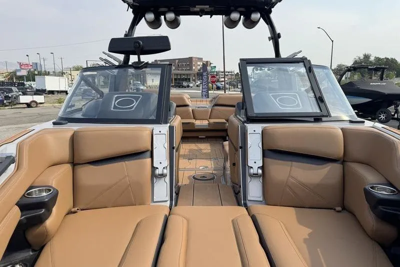 Slide: The Image of 2023 Supra SL boat interior with tan leather seating and open windshield. - 14