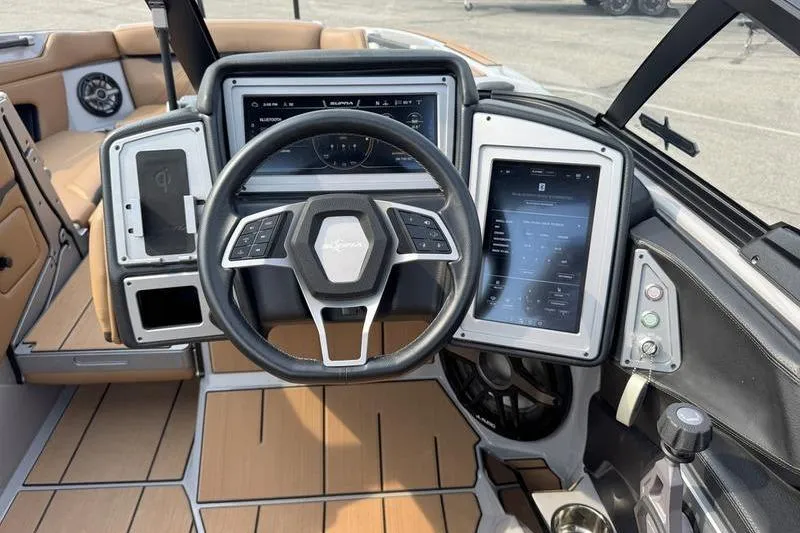 Slide: The Image of 2023 Supra SL boat dashboard with advanced controls and touchscreen displays. - 15