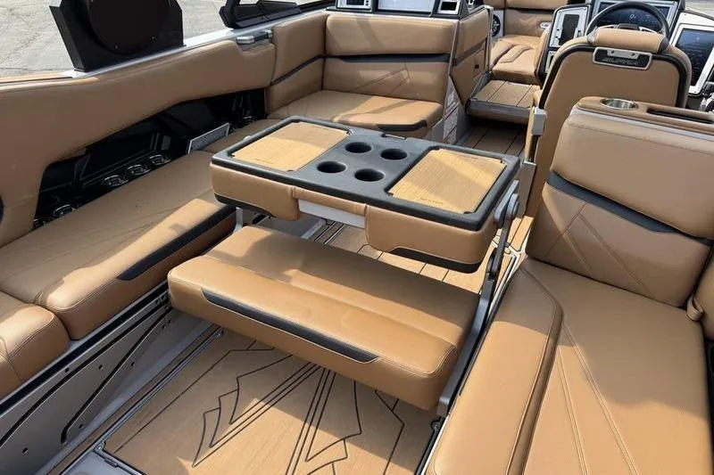 Slide: The Image of Luxurious interior of 2023 Supra SL boat with tan leather seating and cup holders. - 16