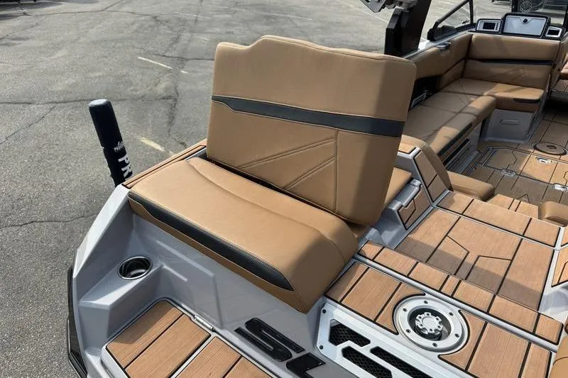 Slide: The Image of 2023 Supra SL boat interior with tan and black seating, featuring modern design and spacious layout. - 17