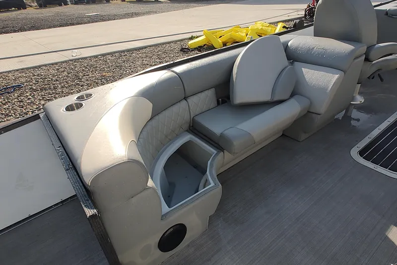 Slide: The Image of 2023 Paradise Pontoon Tritoon interior seating with storage and cup holders. - 4
