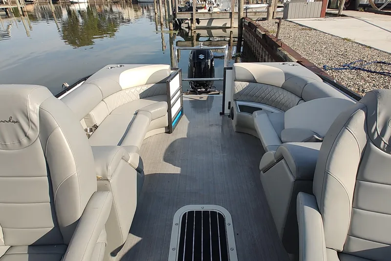 Slide: The Image of 2023 Paradise Pontoon Tritoon with luxurious seating, docked by a calm waterfront. - 7
