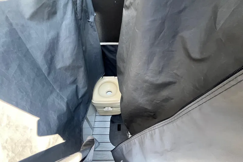 Slide: The Image of Portable toilet in SunCatcher Elite 326C boat, 2022 model, with privacy curtains. - 10