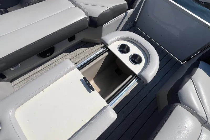 Slide: The Image of 2022 SunCatcher Elite 326C boat interior with cup holders and seating. - 17