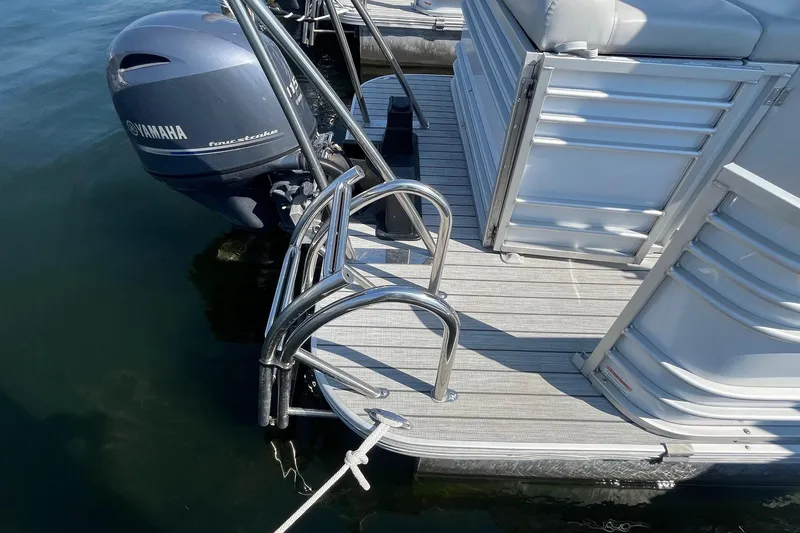 Slide: The Image of 2022 SunCatcher Elite 326C pontoon boat with Yamaha outboard motor and swim ladder. - 5