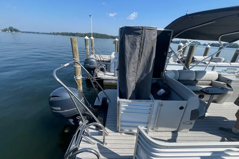 Slide: The Image of 2022 SunCatcher Elite 326C pontoon boat docked with Yamaha outboard motors. - 8