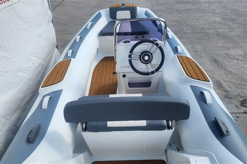 Slide: The Image of 2025 Gala A400L boat interior with steering wheel and wooden accents. - 2