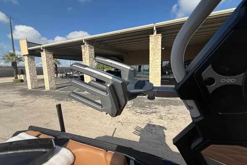 Slide: The Image of 2026 Supra SA 450 boat with advanced wakeboard rack, parked outdoors. - 11