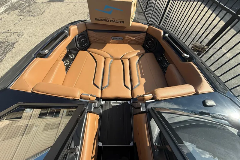 Slide: The Image of 2026 Supra SA 450 boat interior with tan leather seating and board racks. - 15