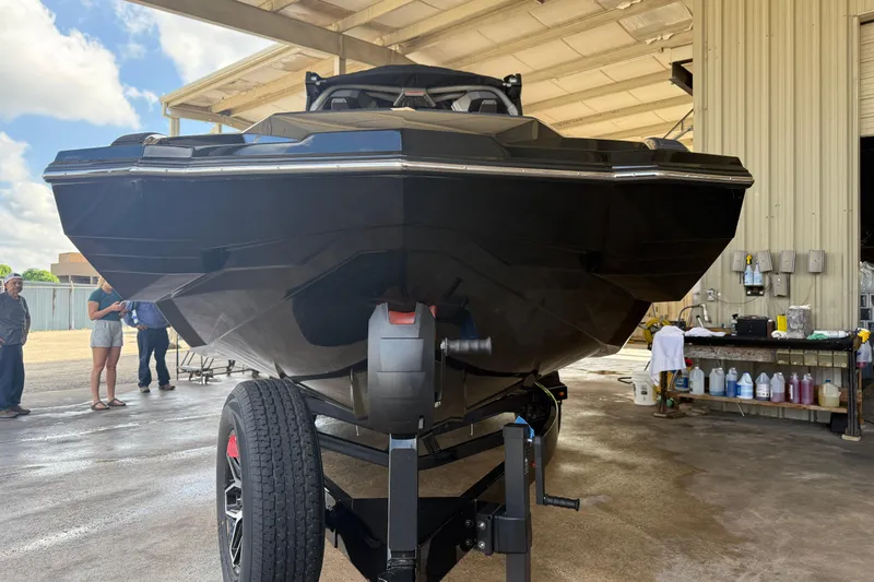 Slide: The Image of 2026 Supra SA 450 boat on trailer in a workshop setting. - 2