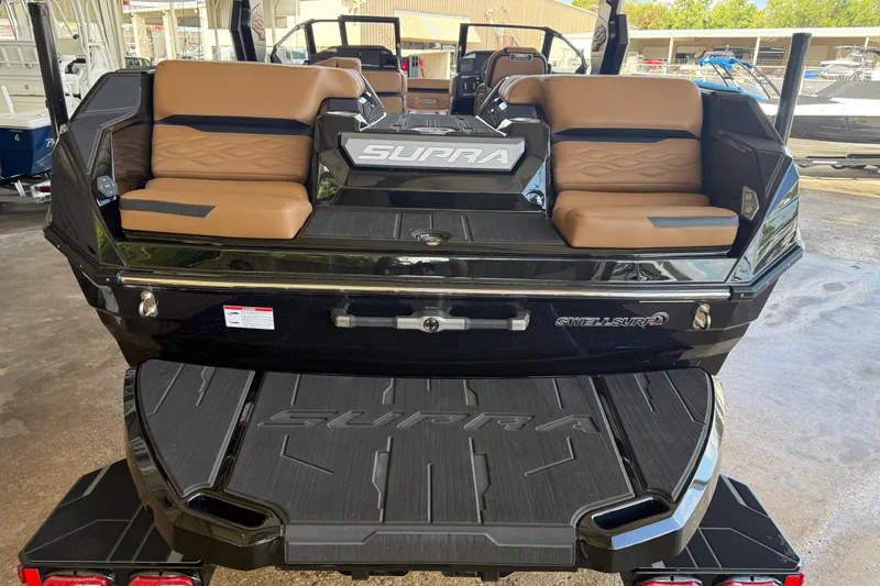 Slide: The Image of 2026 Supra SA 450 boat with tan seating and sleek black design. - 5