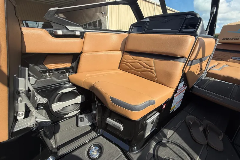 Slide: The Image of 2026 Supra SA 450 boat interior with tan leather seating and cup holders. - 9