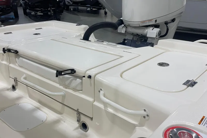 Slide: The Image of 2026 Skeeter SX221 boat deck with storage compartments and motor. - 10