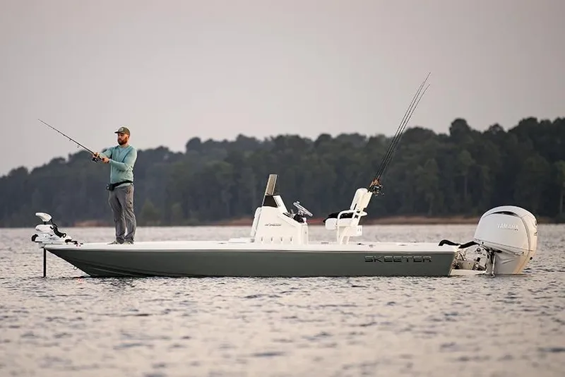 Slide: The Image of Manufacturer Provided Image: Man fishing on a 2026 Skeeter SX221 boat in a serene lake setting. - 11