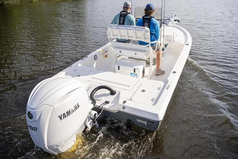 Slide: The Image of Manufacturer Provided Image: 2026 Skeeter SX221 boat with Yamaha engine on a calm lake. - 13