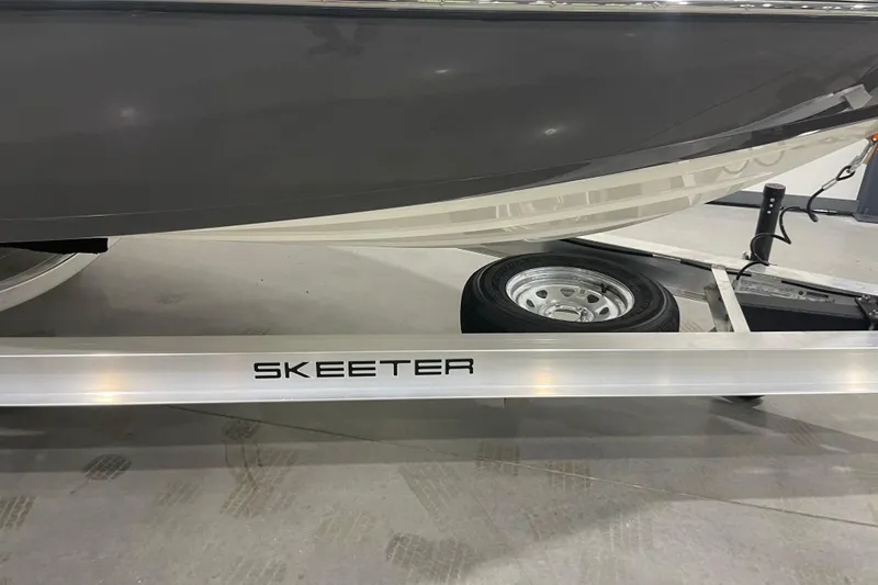 Slide: The Image of 2026 Skeeter SX221 boat on trailer, showcasing sleek design and branding. - 3