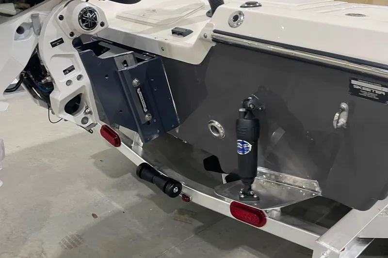 Slide: The Image of 2026 Skeeter SX221 boat transom with hydraulic components and trailer attachment. - 6