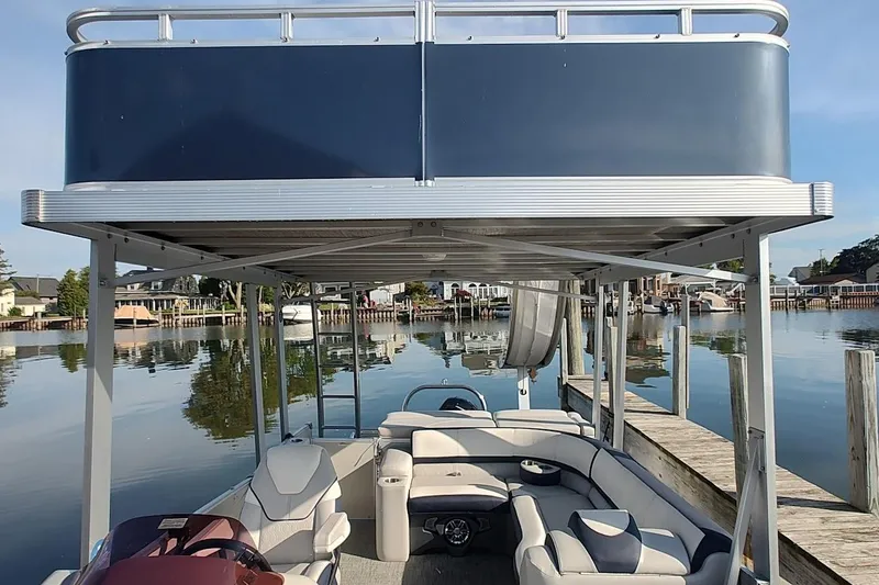 Slide: The Image of 2023 Tahoe Pontoon Cascade Funship docked on a serene lake with upper deck view. - 11