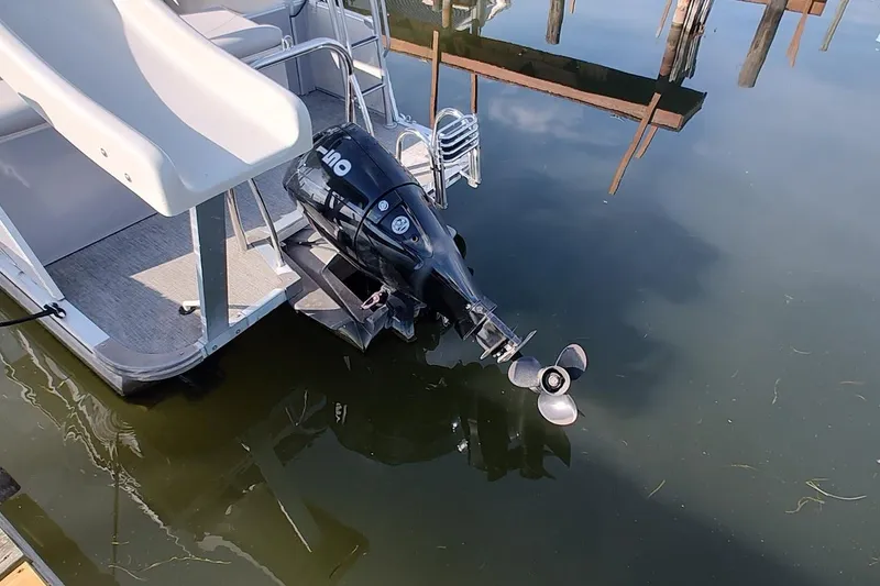 Slide: The Image of 2023 Tahoe Pontoon Cascade Funship with slide and motor in calm water. - 15