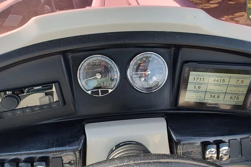 Slide: The Image of Dashboard of 2023 Tahoe Pontoon Cascade Funship with gauges and Garmin display. - 7