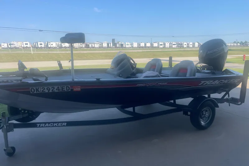Slide: The Image of 2017 Tracker Pro Team 175 TXW boat on trailer, parked outdoors. - 2