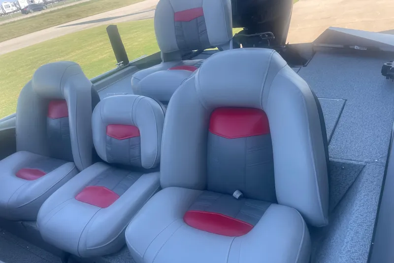 Slide: The Image of 2017 Tracker Pro Team 175 TXW boat interior with gray and red seating. - 6