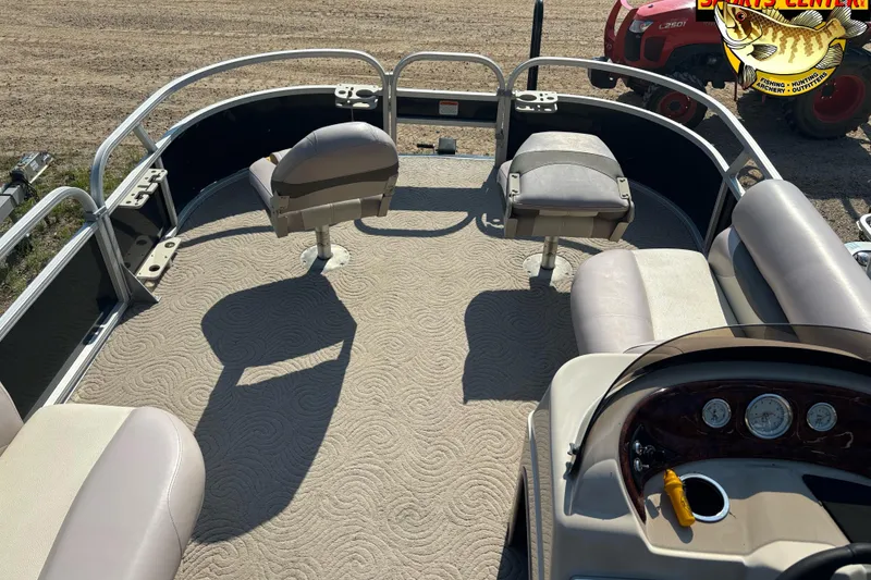 Slide: The Image of 2014 Sun Tracker Fishin' Barge 20 DLX interior with seating and steering console. - 11
