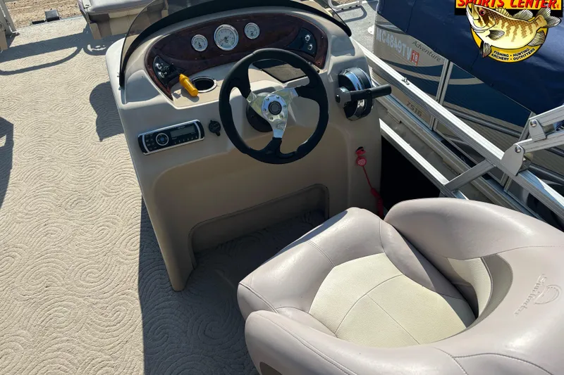 Slide: The Image of 2014 Sun Tracker Fishin' Barge 20 DLX helm with steering wheel and comfortable seating. - 12