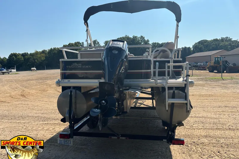 Slide: The Image of 2014 Sun Tracker Fishin' Barge 20 DLX pontoon boat on trailer, outdoor setting. - 4