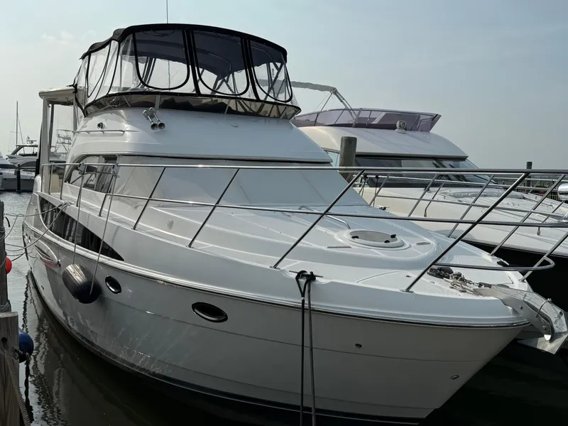 Slide: The Image of 2005 Meridian 459 Motoryacht docked at marina, featuring sleek design and spacious deck. - 1