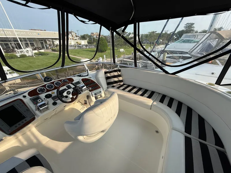Slide: The Image of Luxurious 2005 Meridian 459 Motoryacht cockpit with striped seating and modern controls. - 18