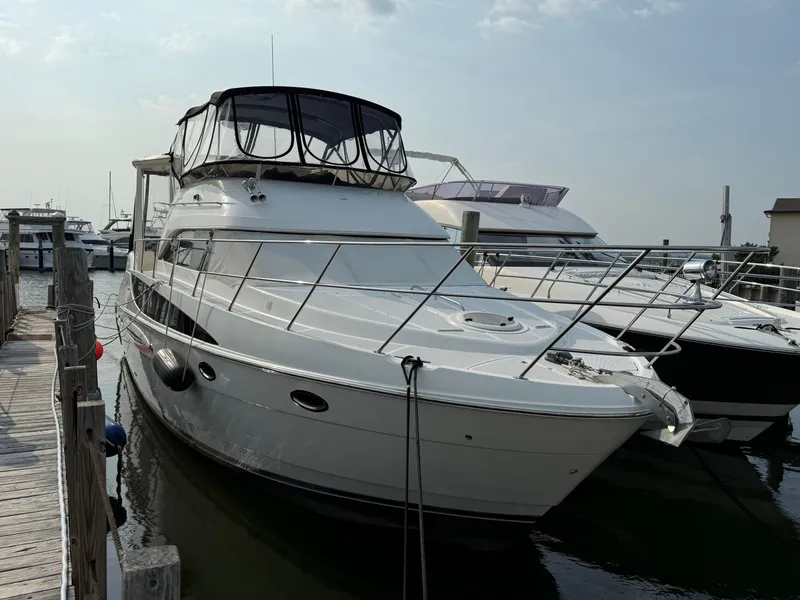 Slide: The Image of 2005 Meridian 459 Motoryacht docked at marina under clear sky. - 2