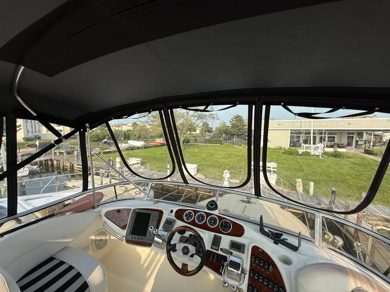 Slide: The Image of 2005 Meridian 459 Motoryacht cockpit with steering wheel, gauges, and navigation equipment. - 20