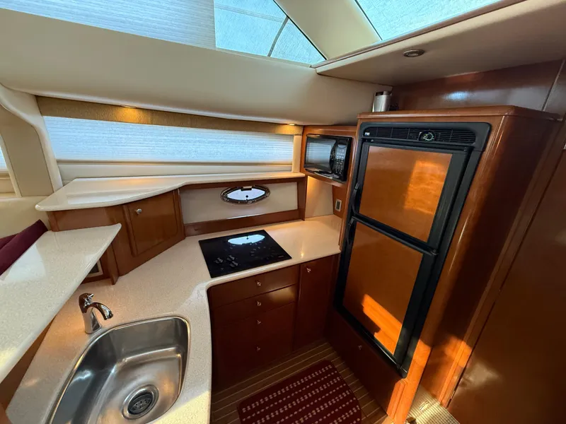 Slide: The Image of Luxurious kitchen interior of 2005 Meridian 459 Motoryacht with modern appliances and wood finish. - 33