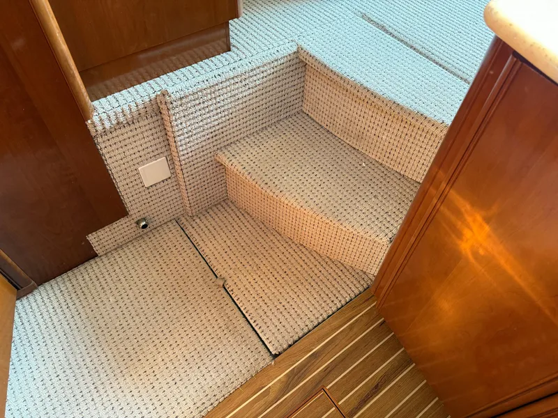 Slide: The Image of Interior stairs of 2005 Meridian 459 Motoryacht with carpeted steps and wooden flooring. - 36